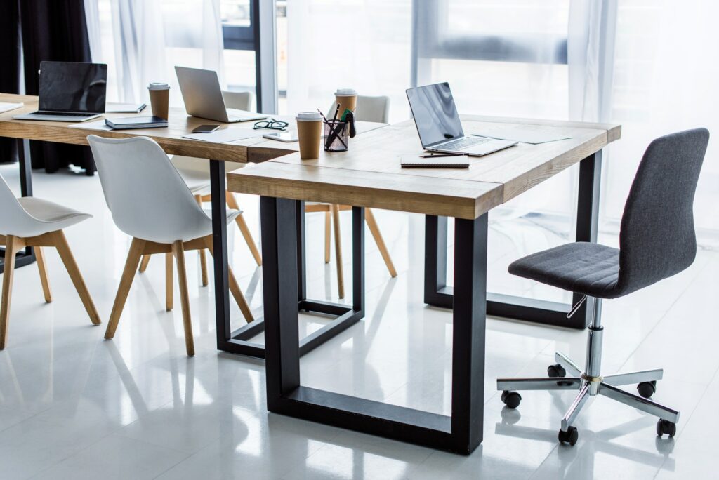 interior of business office with laptops on tables